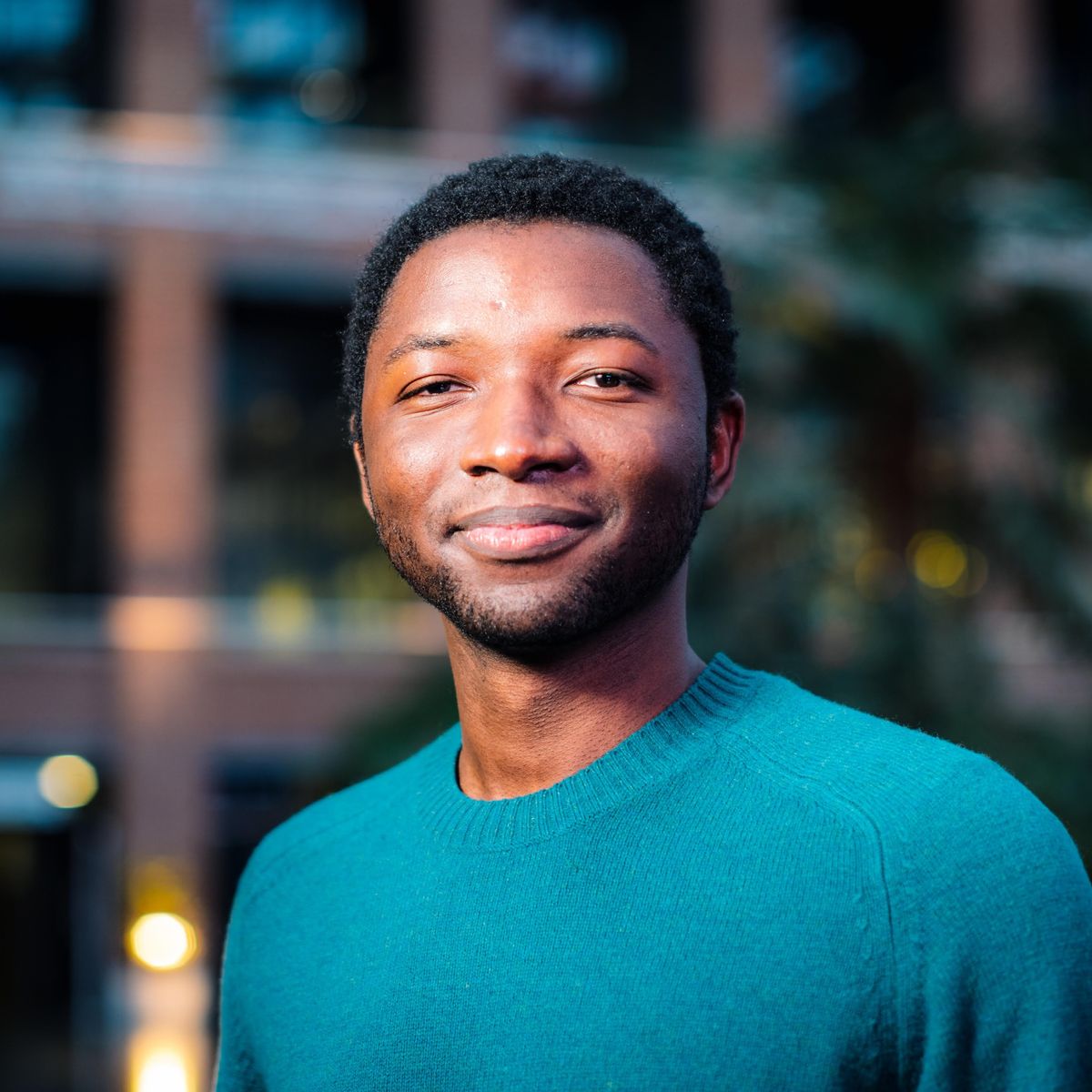 A picture of Yannick in a green sweater